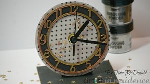Handmade clock featuring gold embossed numbers.