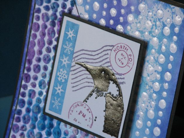 Winter themed card featuing a penguin image, lots of texture elements and snowflakes.