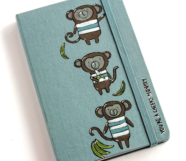 A moleskin notebook personalized with monkey images by stamping and coloring in with Tsukineko, Imagine and Gel Pen inks.