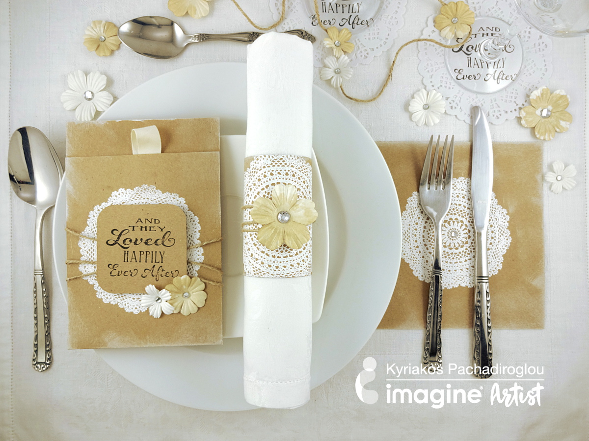 A simple and elegant shabby chic wedding table setting including a napkin ring, menu card holder, cutlery placeholder and glass coasters all with a white doily theme.