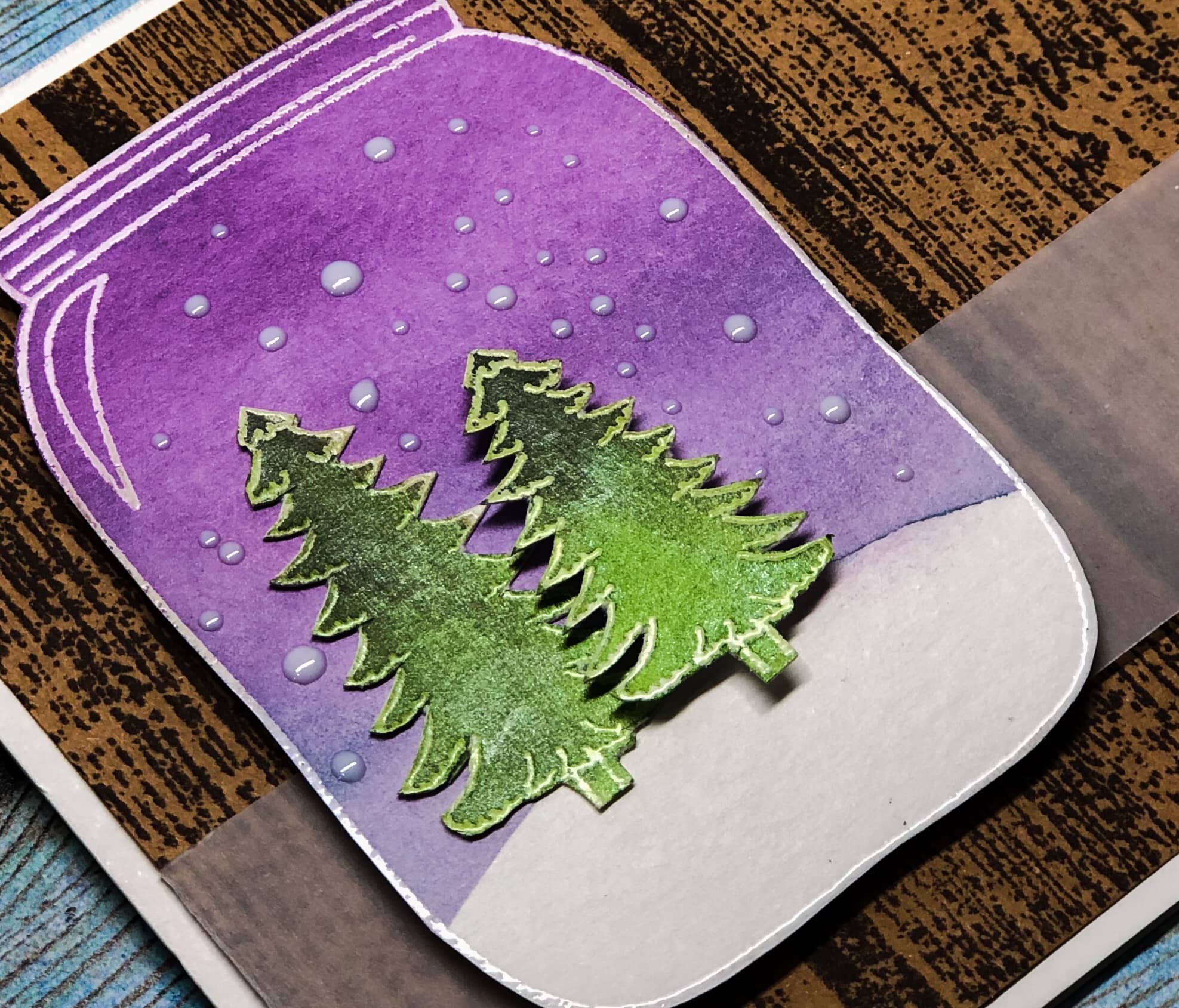 Handmade card featuring a winter tree scene in a mason jar shape.