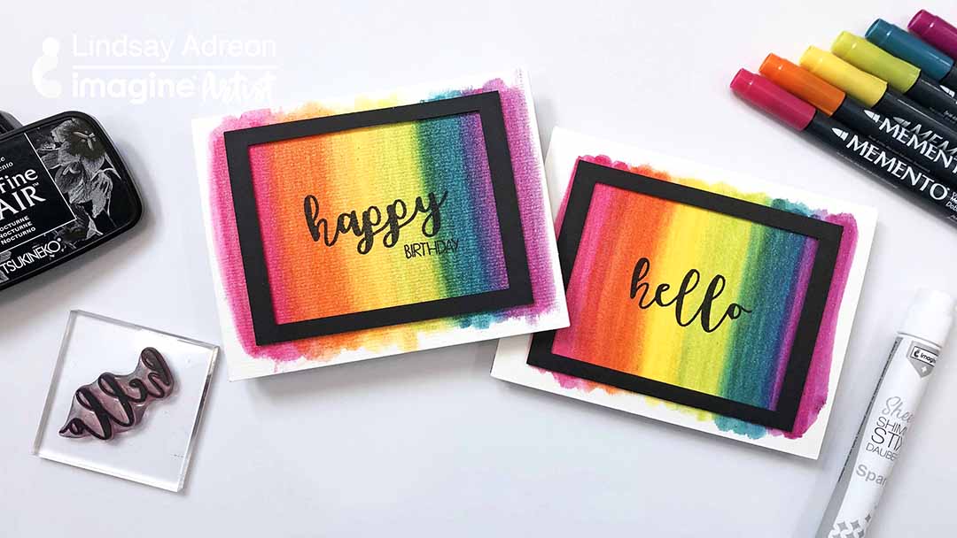 Two handmade cards featuring sparkly rianbow backgrounds made using Memento Markers and Sheer Shimmer Stix.
