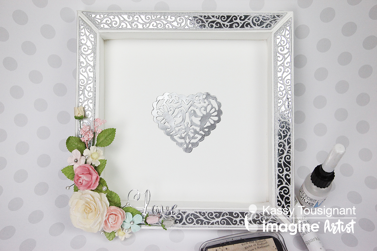 Handmade frame for guests to sign at a wedding in silver and white