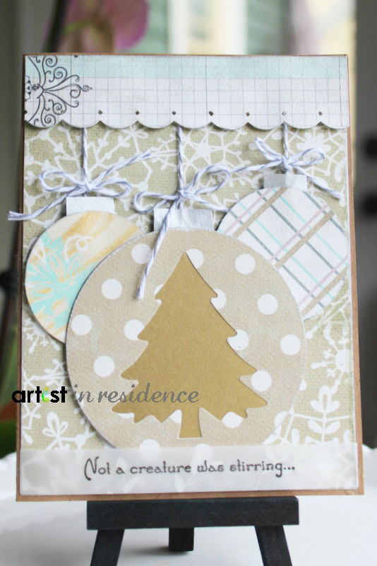 Handmade christmas card with cut out images of round christmas ornaments and the sentiment 