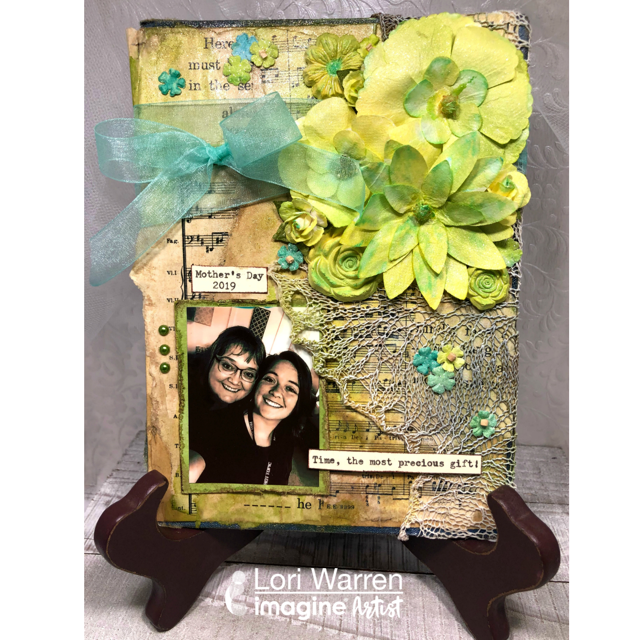 Handmade Mother's Day Memory board in bright greeens made by applying mixed media techniques to a book cover.